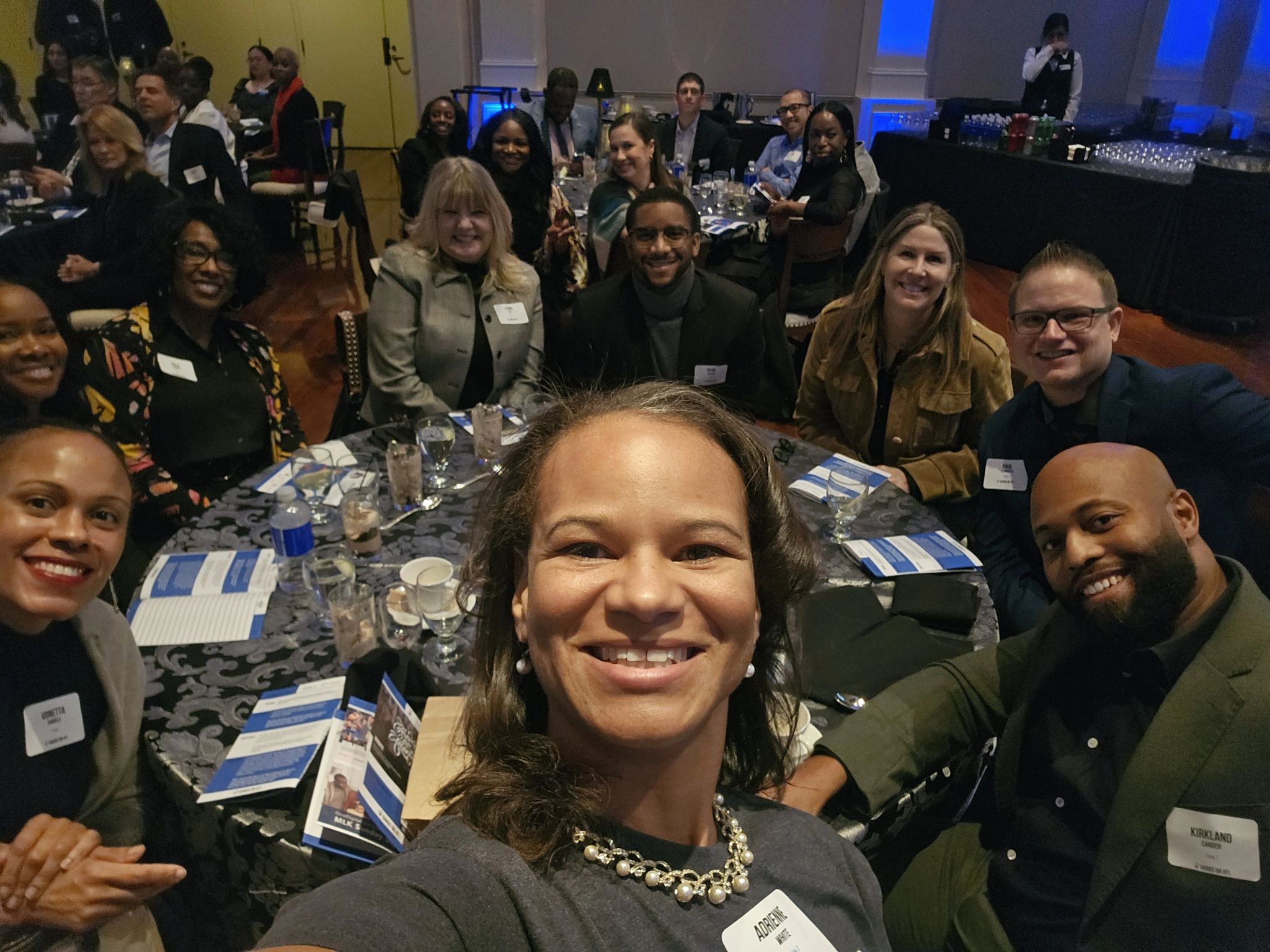 Adrienne White and others seated around a table at the 2024 MLK Day Sunday Supper hosted by Hands on Atlanta.